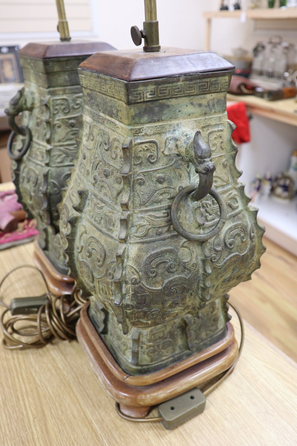 A pair of Chinese archaistic bronze lamps, height 47cm excl. light fitting